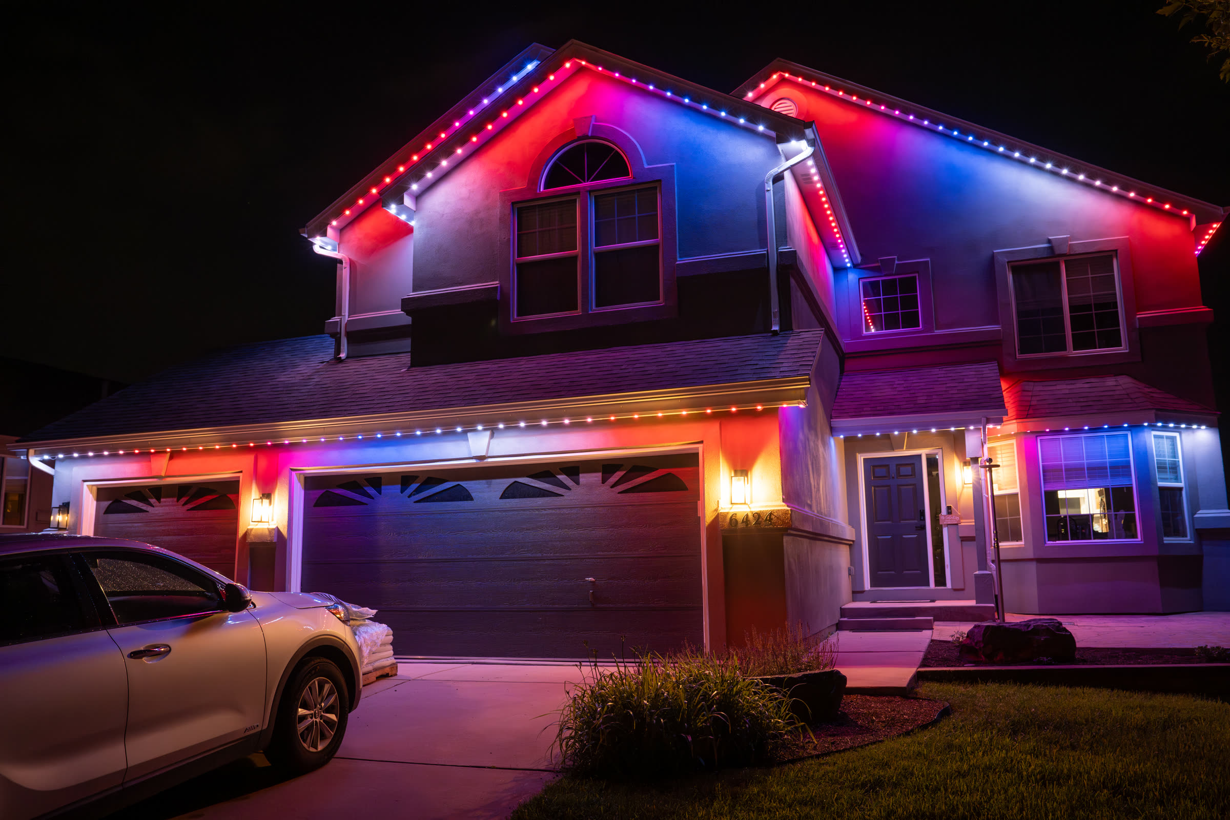 AFTERGLO permanent RGB roofline lighting glowing red, white, and blue at night