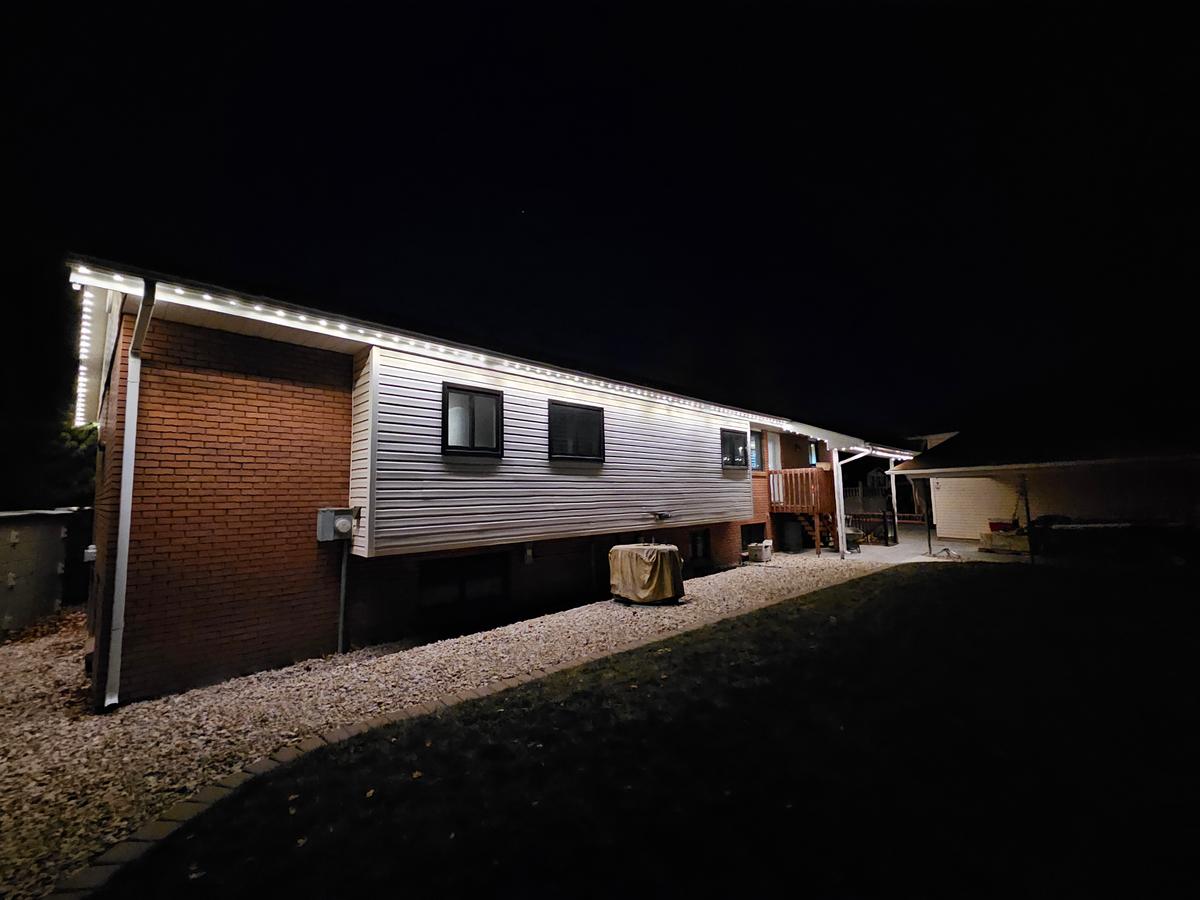 Full warm white roofline install at night