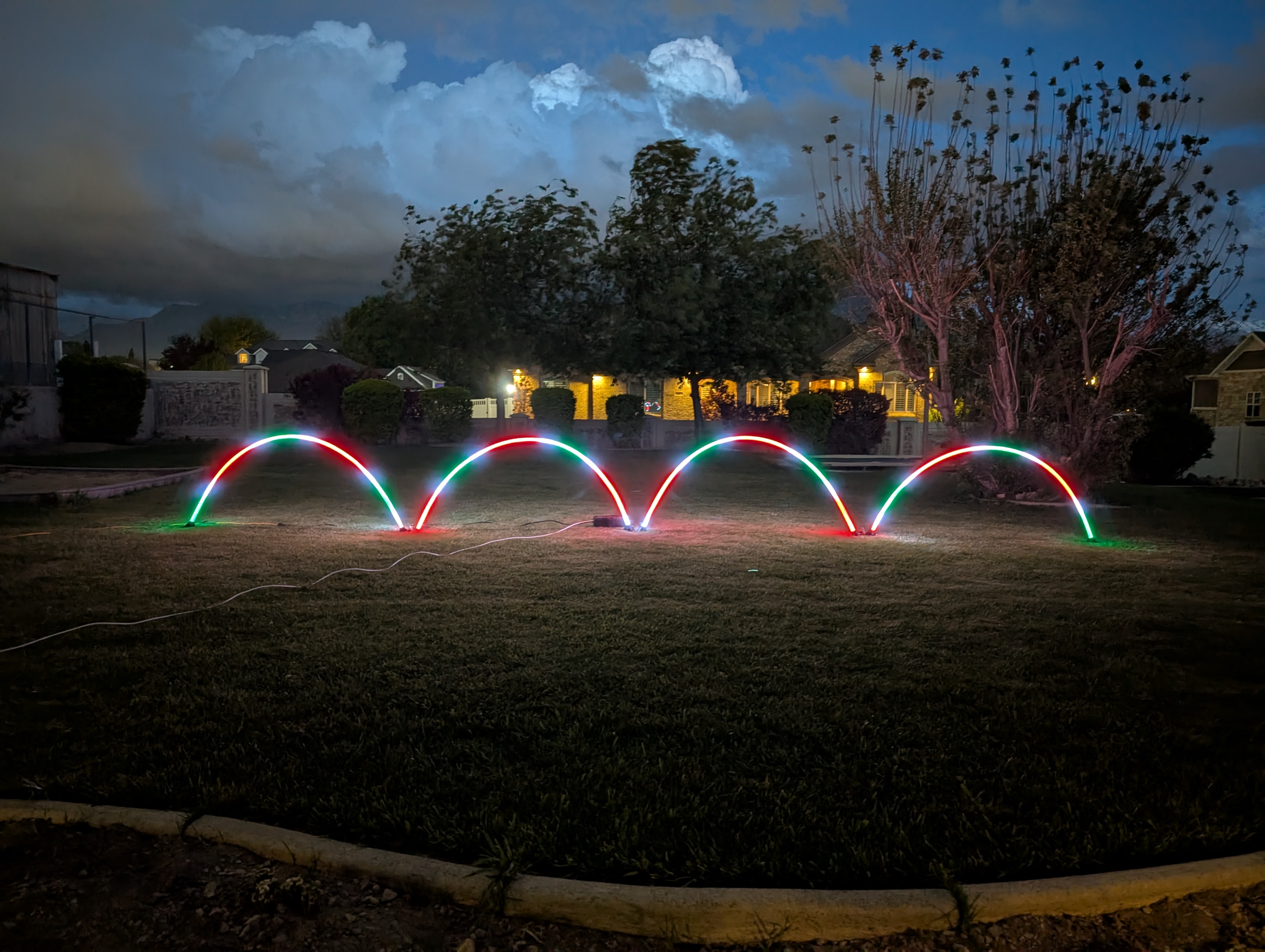 AFTERGLO arches in a row across a residential lawn