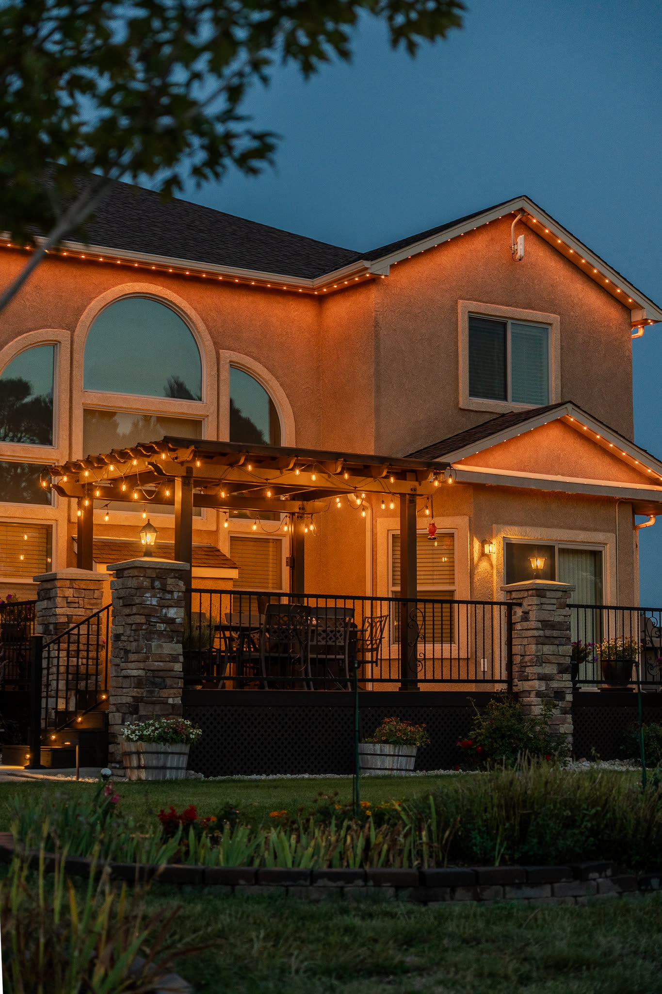 Home with warm white permanent LED accent lighting on a pergola