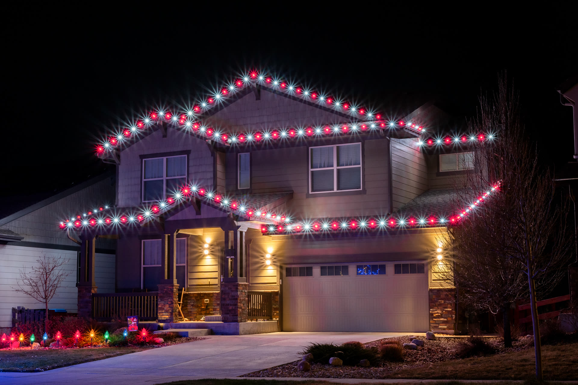 Red and white sparkling Christmas lights along a roofline