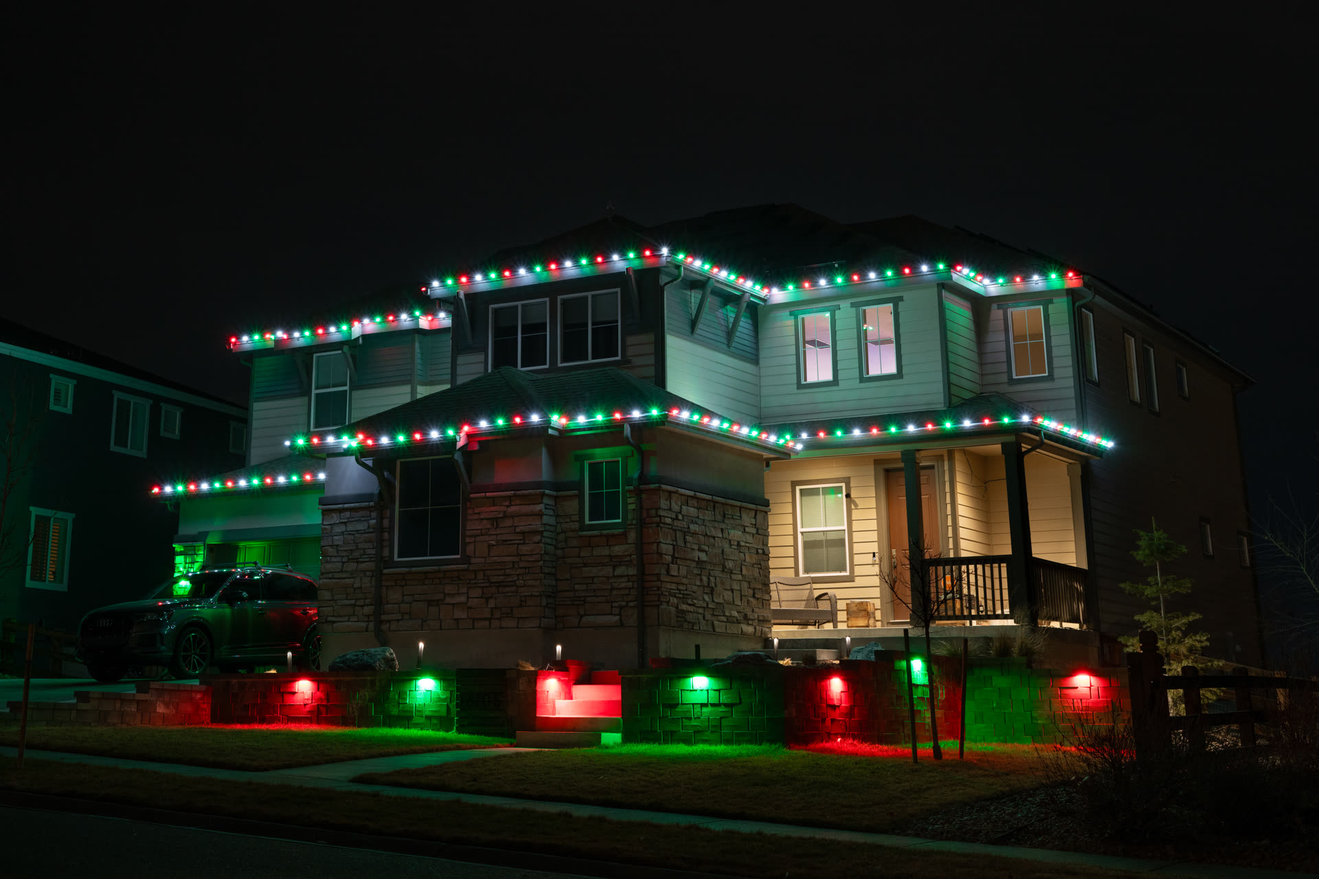 Red and green Christmas string lights with matching uplighting